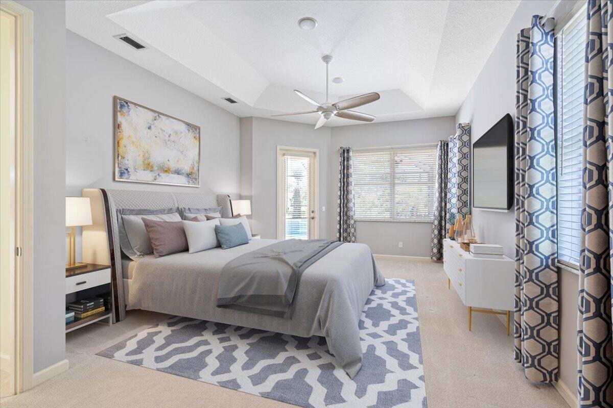 8332 Muirfield Way Port St. Lucie, FL 34986 - Photo 37 of 55 a spacious bedroom with a large bed and a chandelier