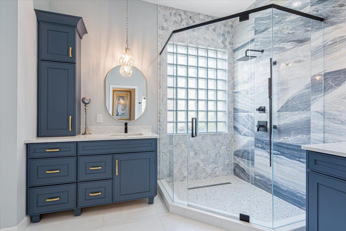 8332 Muirfield Way Port St. Lucie, FL 34986 - Photo 38 of 55 a bathroom with a granite countertop sink a mirror and shower