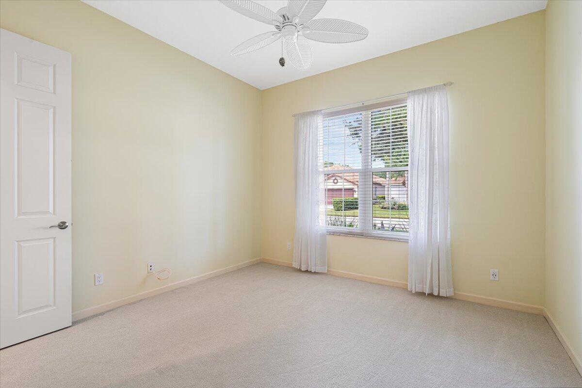 8332 Muirfield Way Port St. Lucie, FL 34986 - Photo 41 of 55 an empty room with a window and a ceiling fan