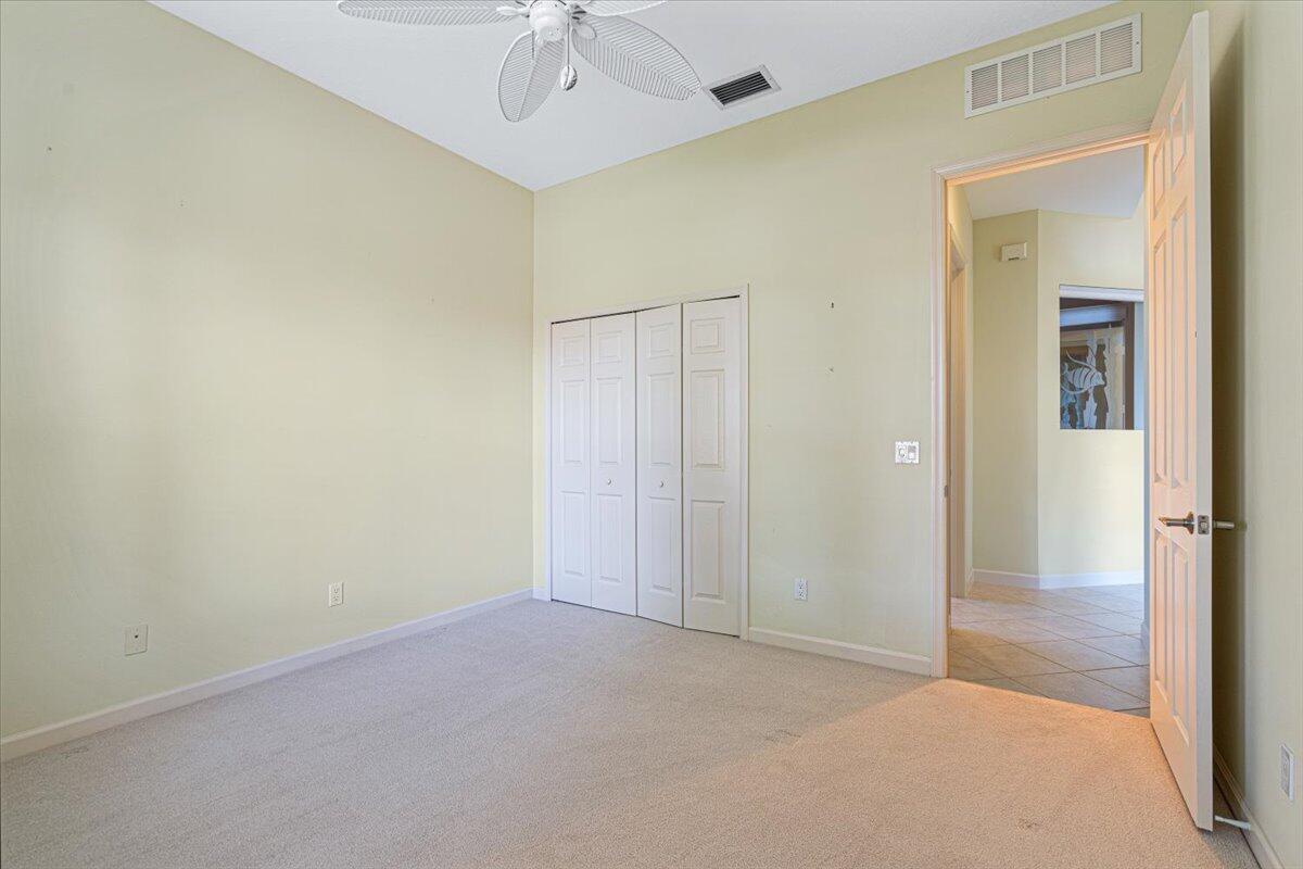 8332 Muirfield Way Port St. Lucie, FL 34986 - Photo 42 of 55 an empty room with a empty space and a ceiling fan