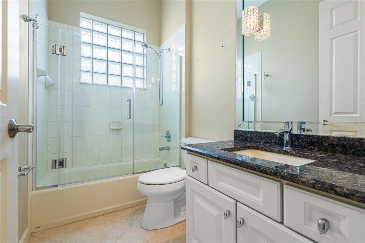 8332 Muirfield Way Port St. Lucie, FL 34986 - Photo 43 of 55 a bathroom with a granite countertop sink a toilet and shower
