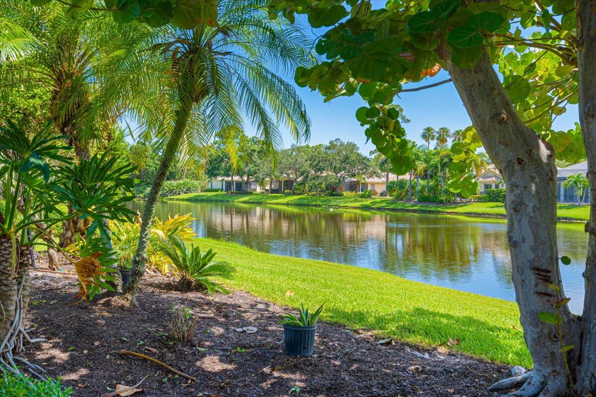 8332 Muirfield Way Port St. Lucie, FL 34986 - Photo 55 of 55 a view of a lake with a building in the background