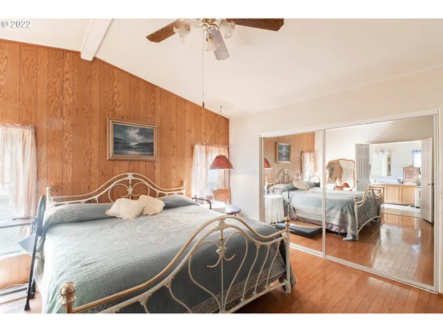 a dining room with furniture a chandelier and wooden floor