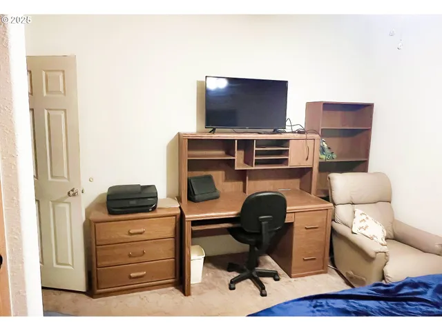 a bed sitting in a bedroom next to a window
