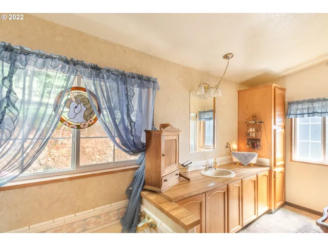 a living room with a bed furniture and a window