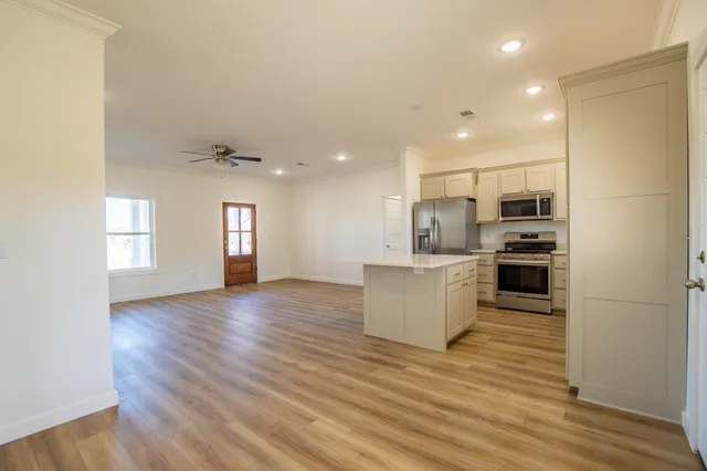 a view of kitchen with sink and refrigerator
