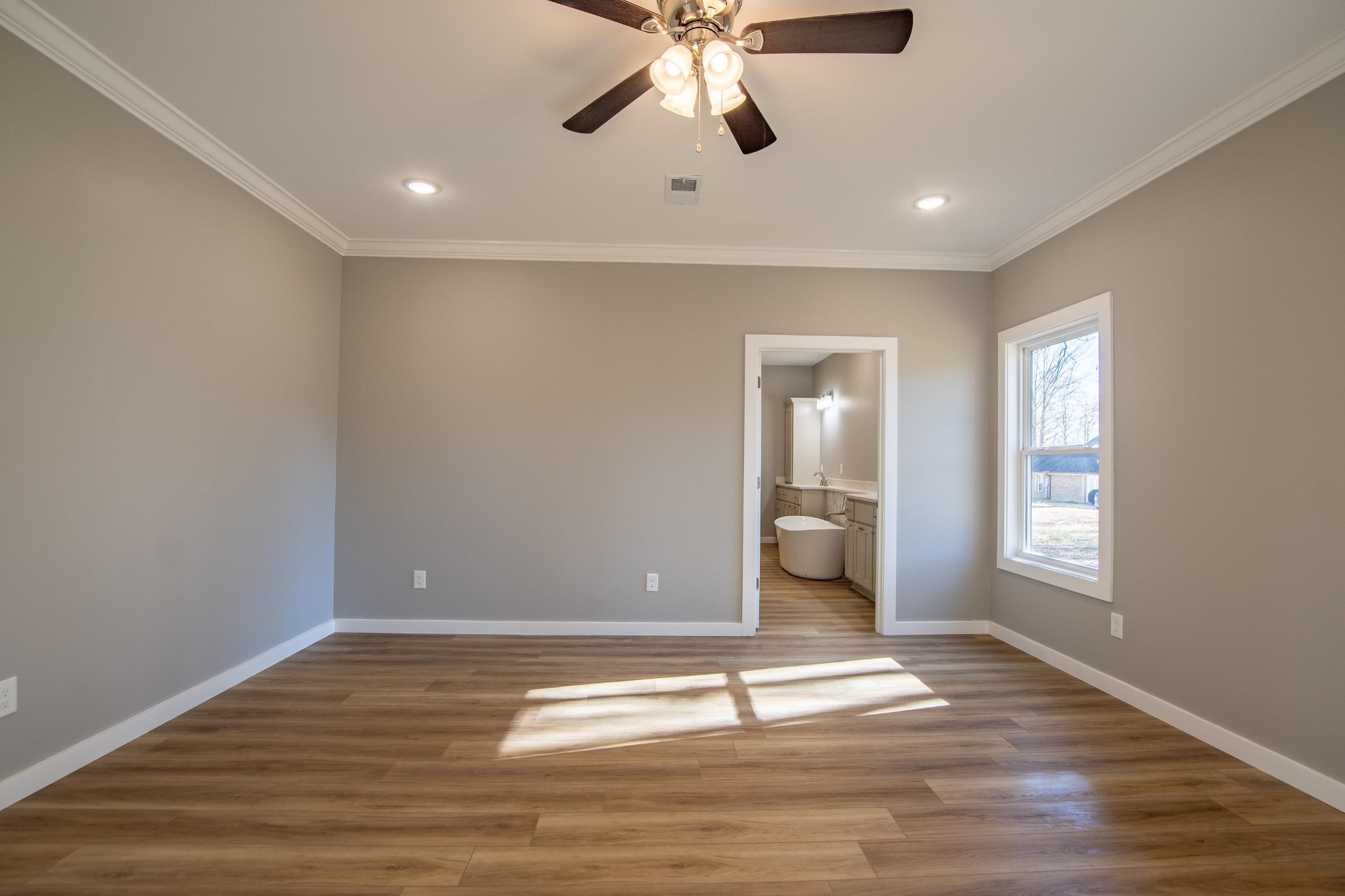 113 Braxton Lane Corinth, MS 38834 - Photo 16 of 39 a view of an empty room with wooden floor and a window