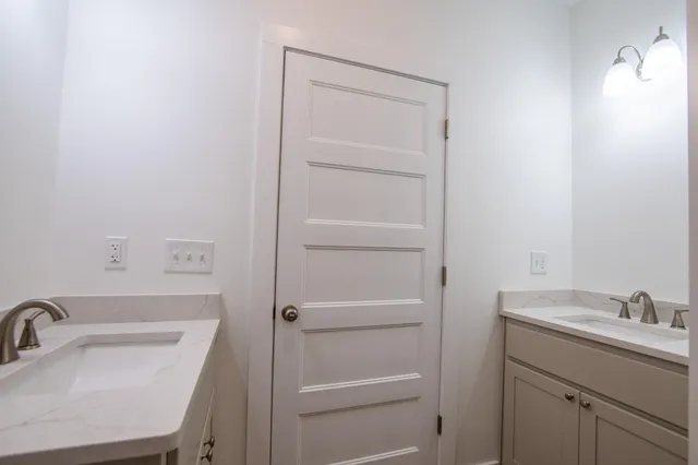 a bathroom with a sink a toilet and vanity