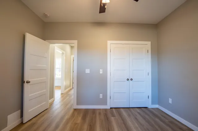 wooden floor and closet area with wooden floor