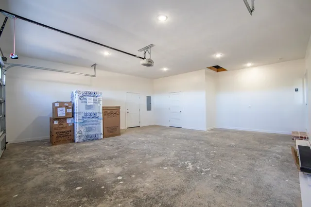an empty room with furniture and natural light