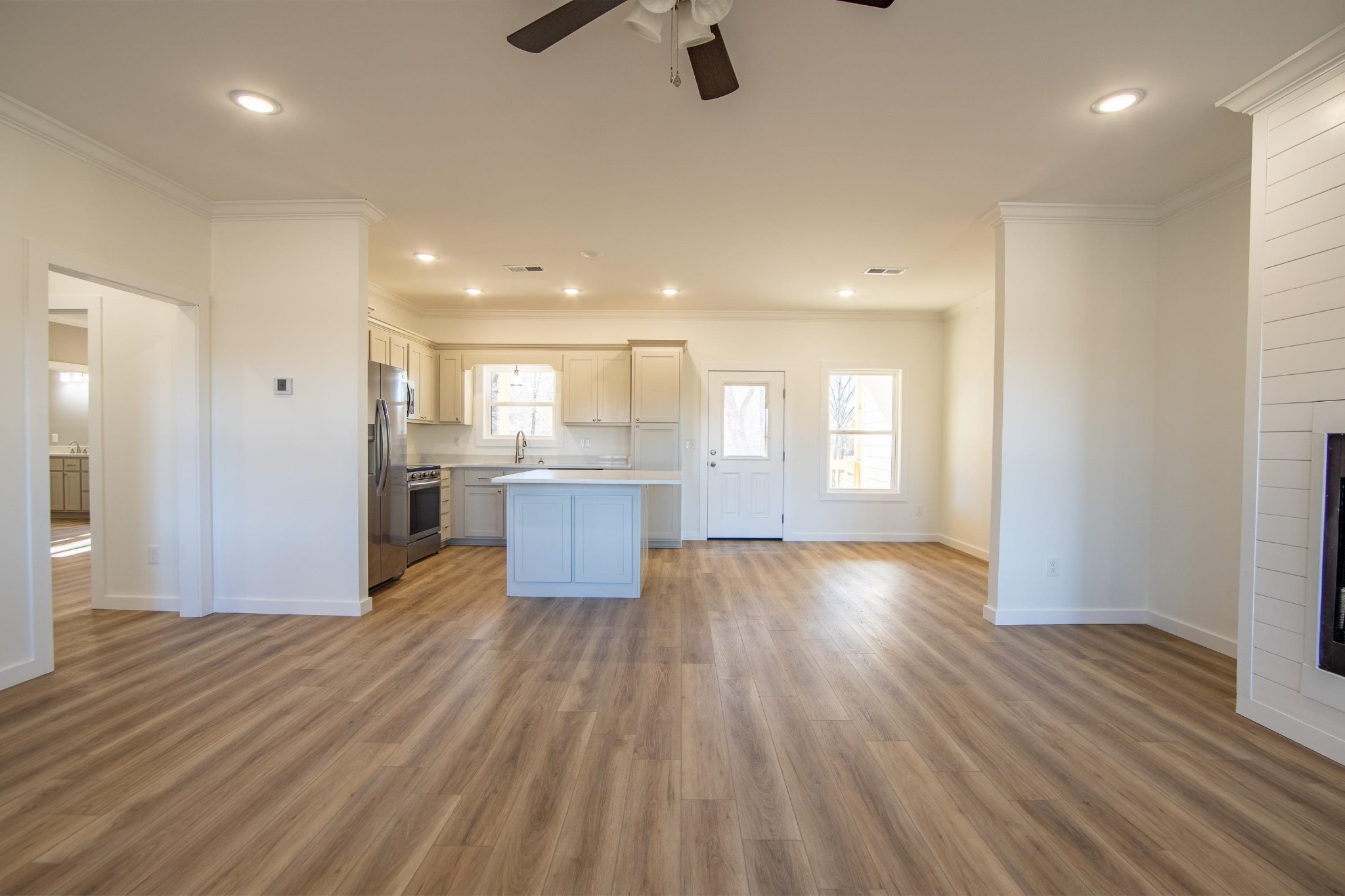 113 Braxton Lane Corinth, MS 38834 - Photo 6 of 39 a view of kitchen and empty room with wooden floor