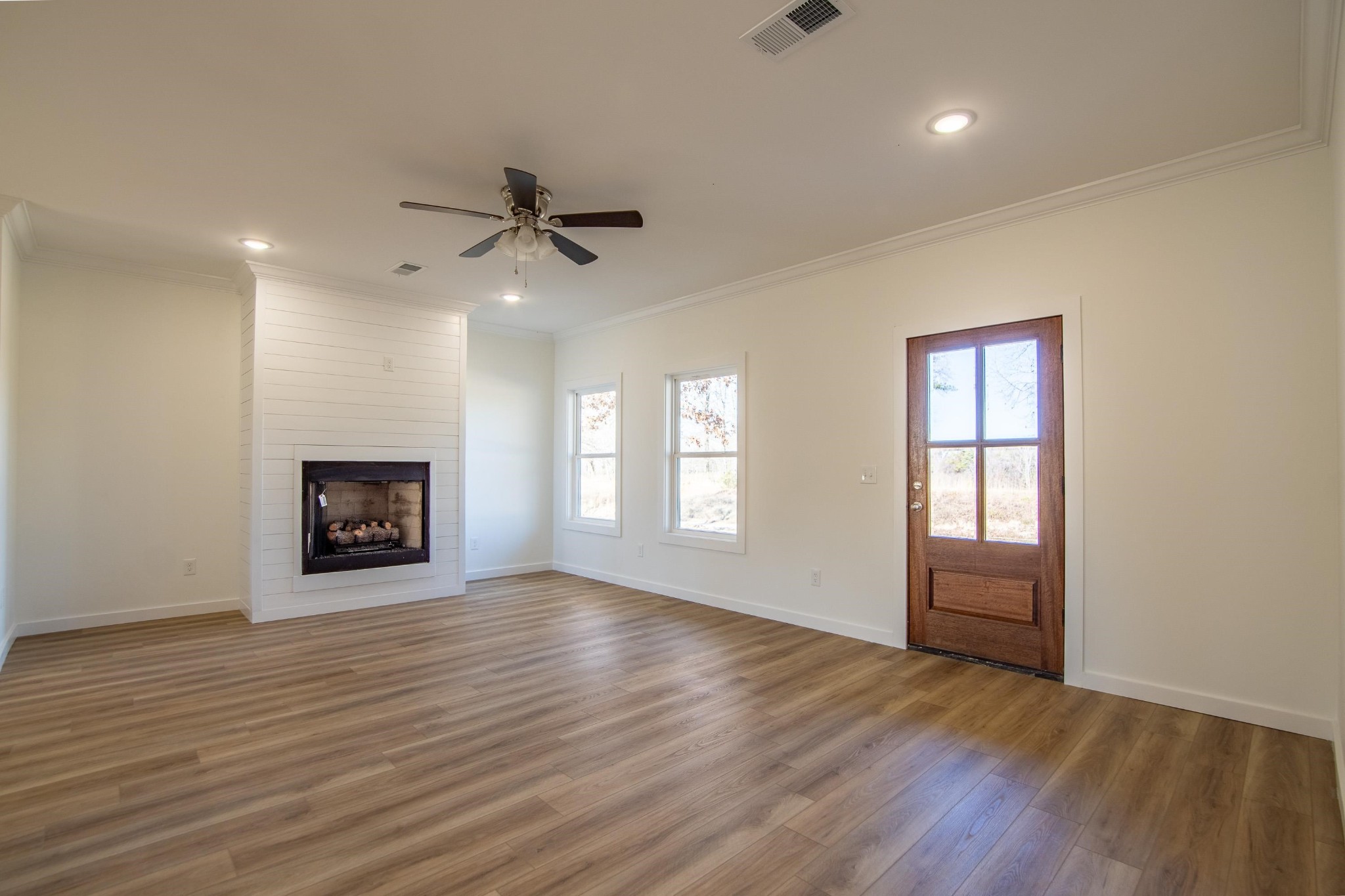 113 Braxton Lane Corinth, MS 38834 - Photo 7 of 39 an empty room with windows fireplace and a sink