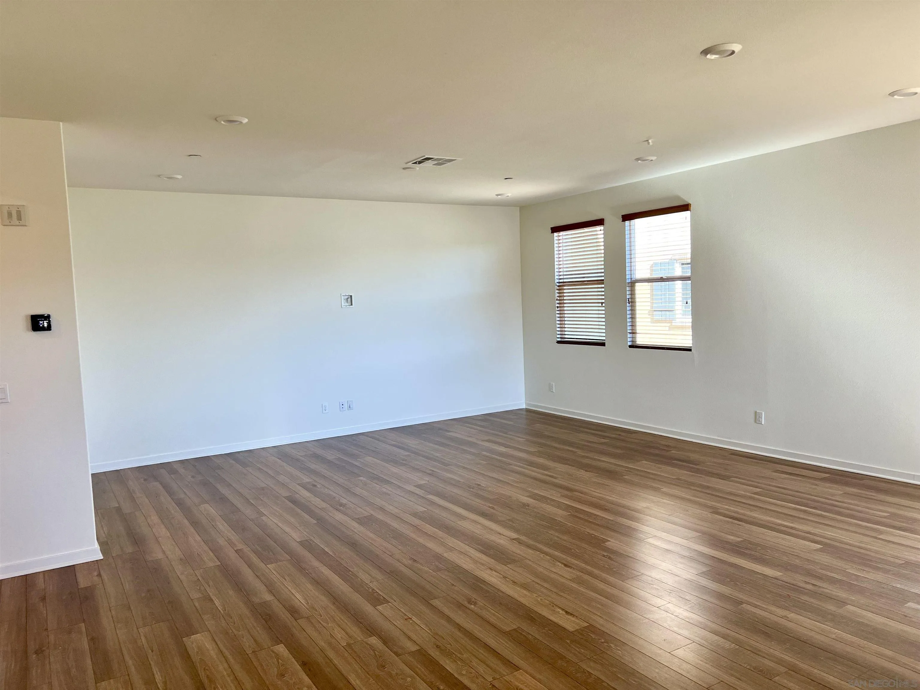 415 Mission Villas Road San Marcos, CA 92069 - Photo 13 of 23 an empty room with wooden floor and windows