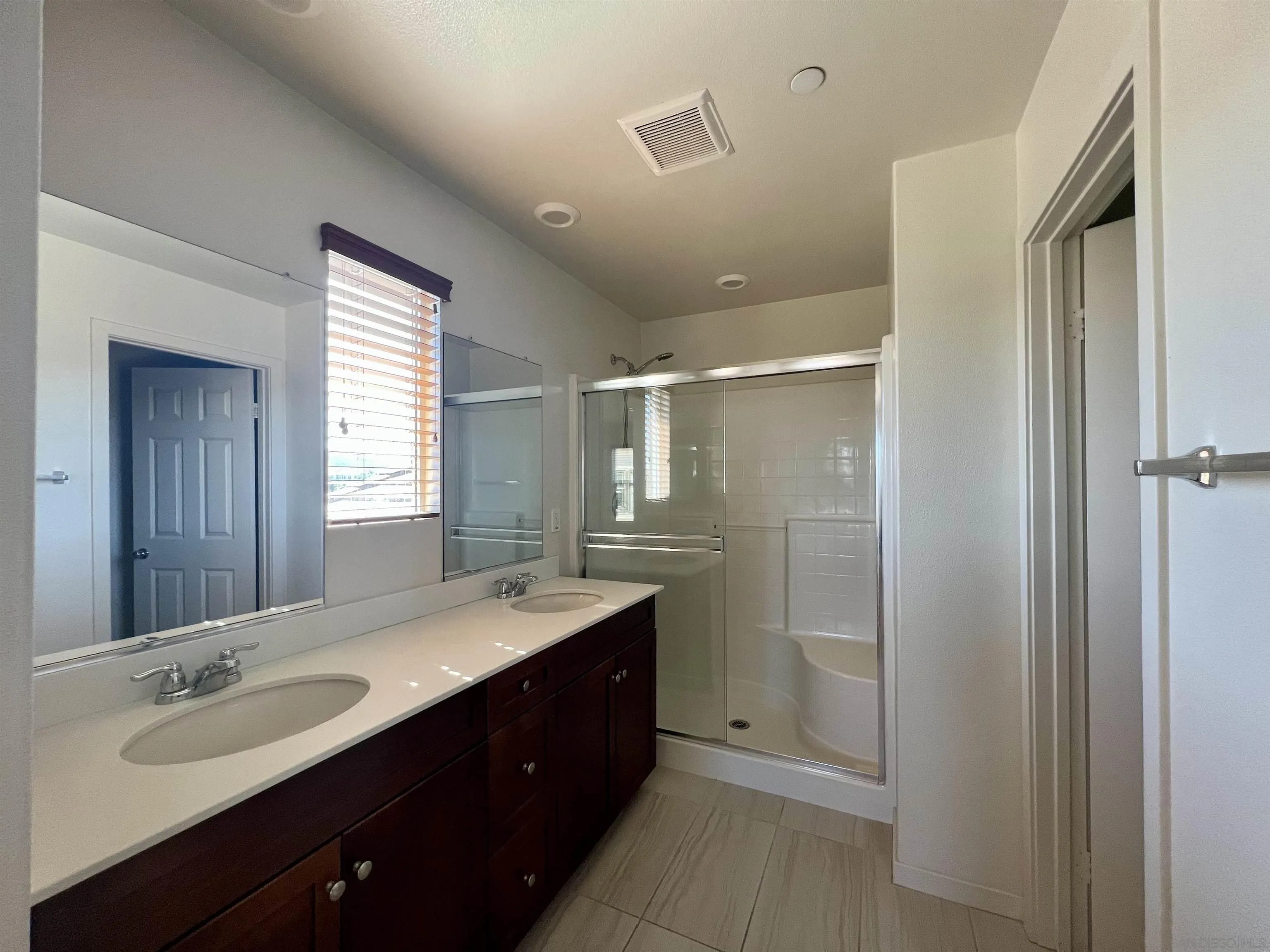 415 Mission Villas Road San Marcos, CA 92069 - Photo 17 of 23 a bathroom with a double vanity sink mirror and shower