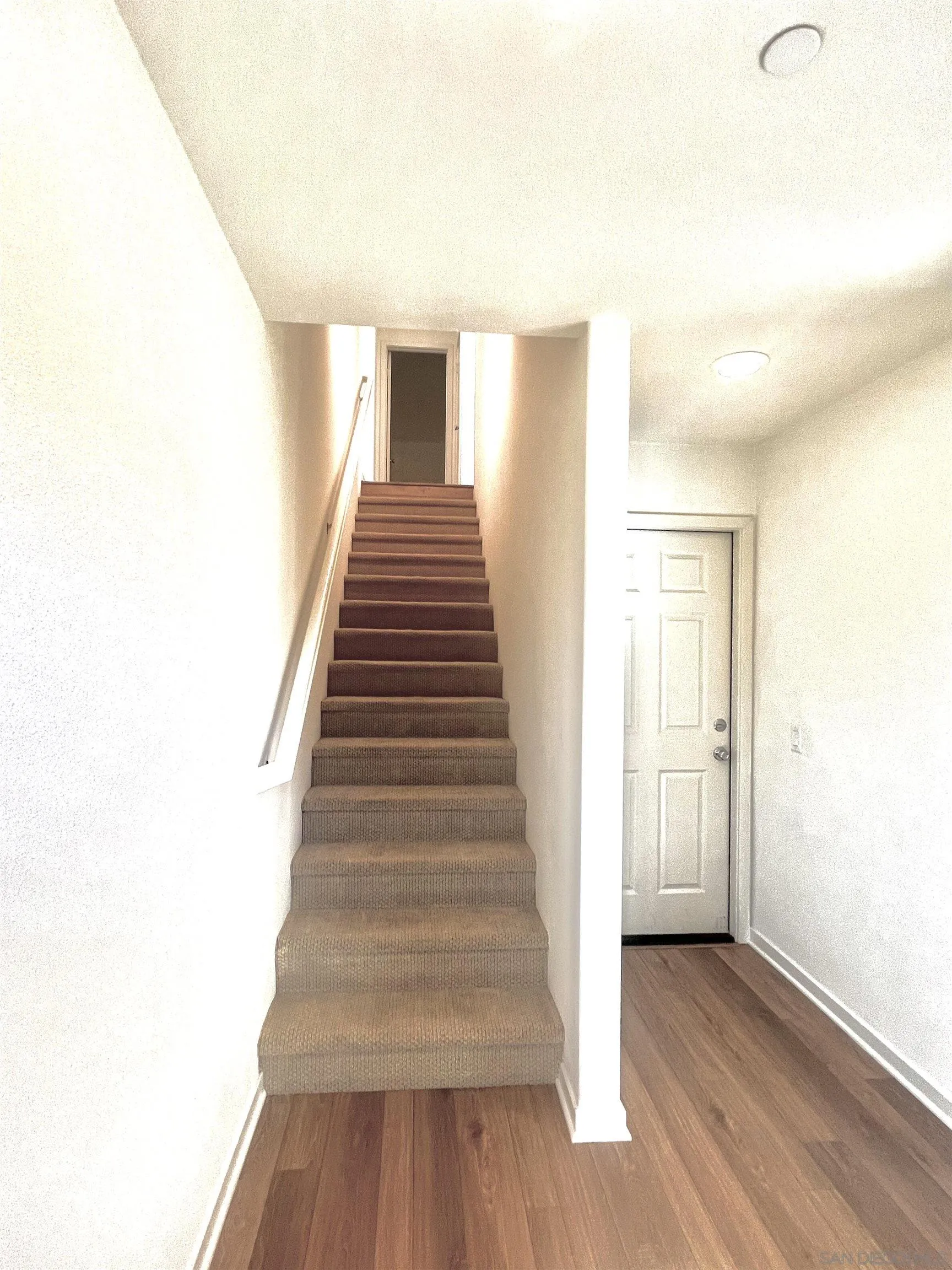 415 Mission Villas Road San Marcos, CA 92069 - Photo 3 of 23 a view of a hallway with wooden floor and staircase