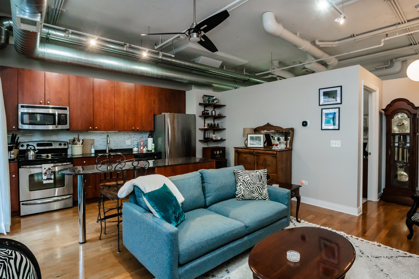 565 West Quincy Street, Unit 710 Chicago, IL 60661 - Photo 11 of 22 a living room with stainless steel appliances furniture and a kitchen view