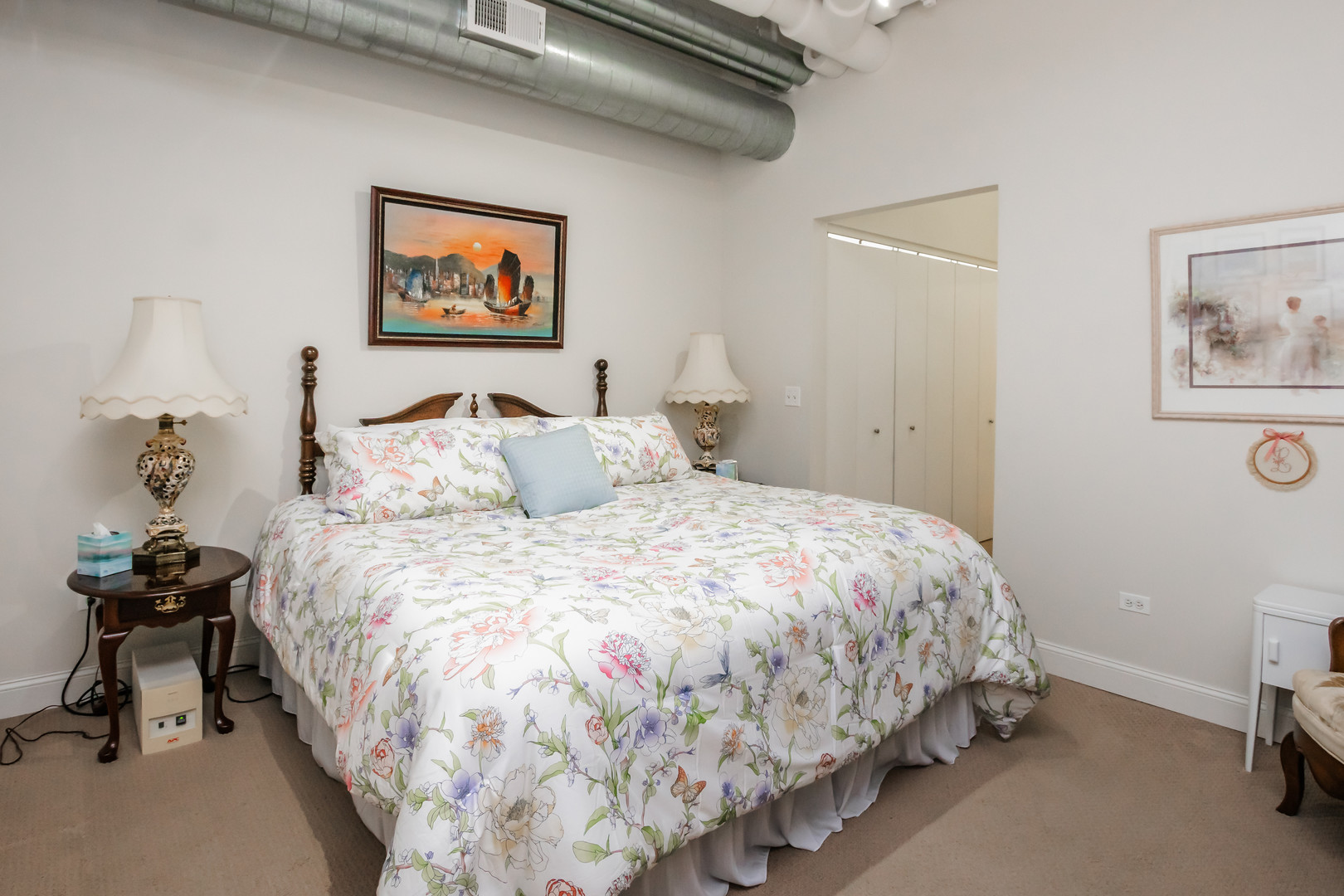 565 West Quincy Street, Unit 710 Chicago, IL 60661 - Photo 15 of 22 a bedroom with bed and painting on the wall