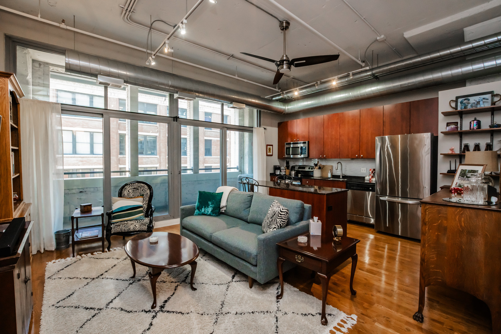 565 West Quincy Street, Unit 710 Chicago, IL 60661 - Photo 10 of 22 a living room with furniture a flat screen tv and a table