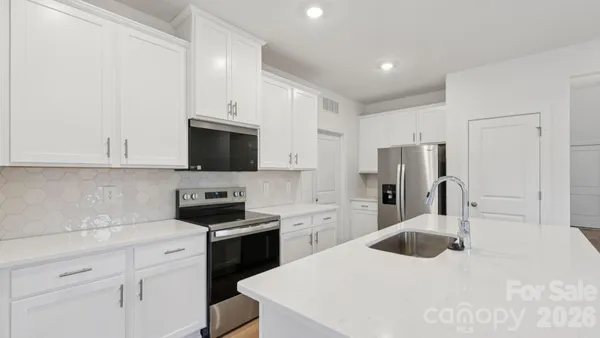 a kitchen with a sink a stove and refrigerator