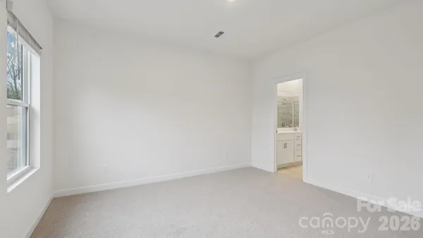 a view of an empty room and a window