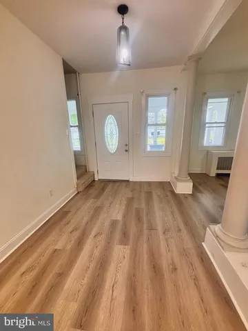 a view of empty room with wooden floor