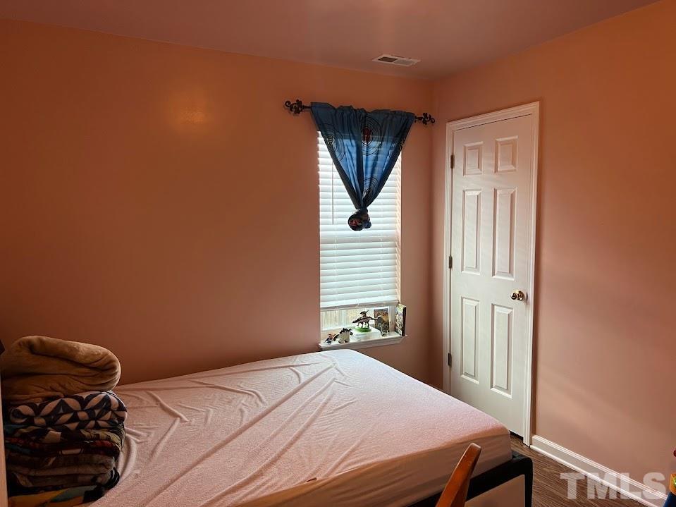 4030 Green Jacket Trail Raleigh, NC 27610 - Photo 20 of 21 a bedroom with a bed and a window