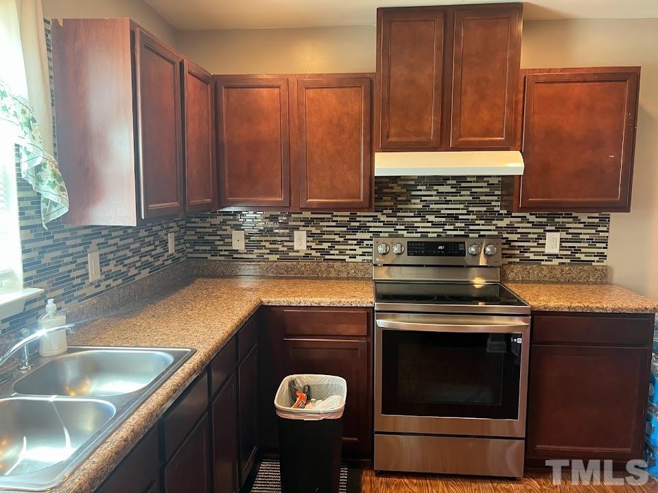 4030 Green Jacket Trail Raleigh, NC 27610 - Photo 8 of 21 a kitchen with a sink and a stove