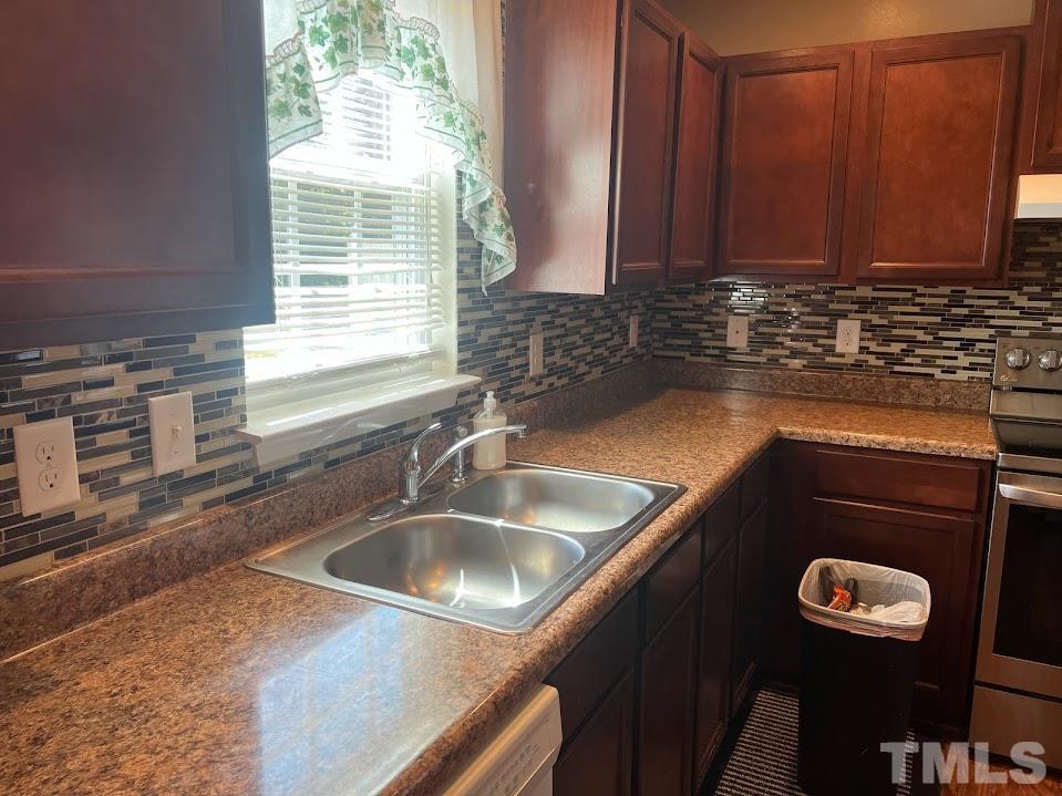4030 Green Jacket Trail Raleigh, NC 27610 - Photo 9 of 21 a kitchen with a sink cabinets and window