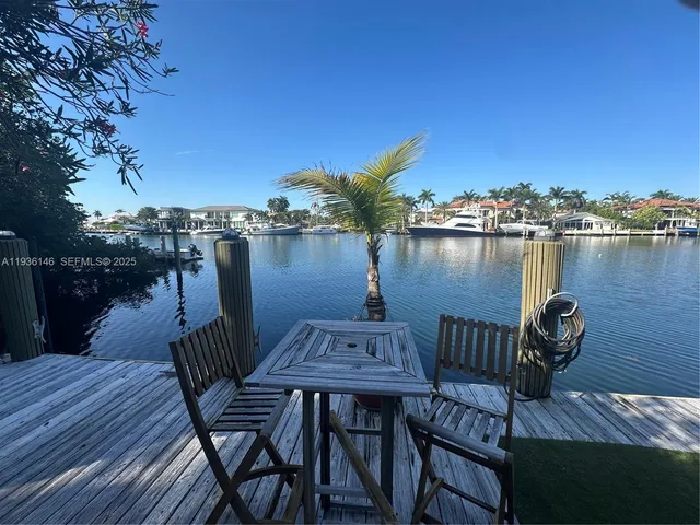 a view of a lake with table and chairs