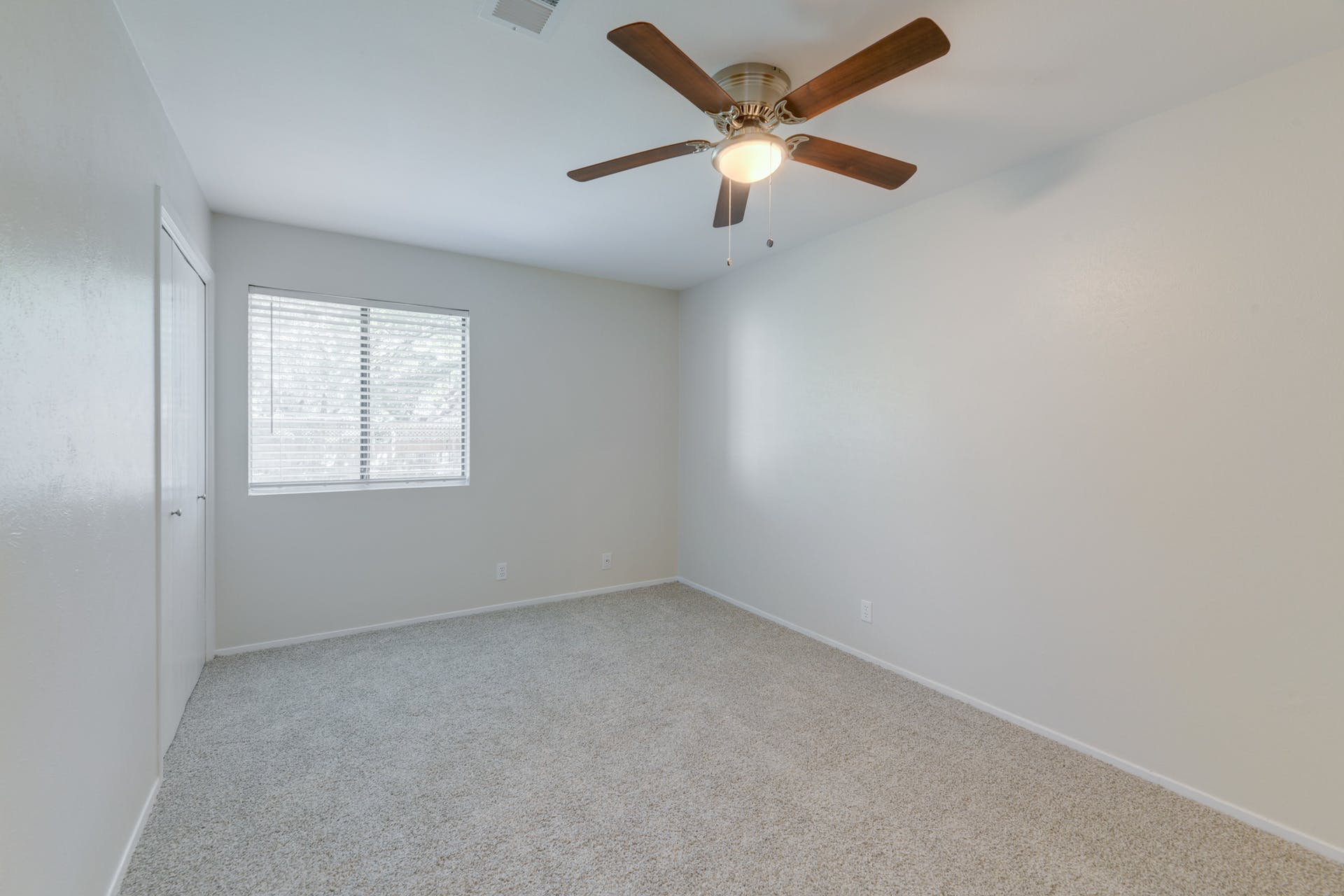 12603 Teague Trail, Unit B Austin, TX 78729 - Photo 10 of 14 an empty room with a window and a fan