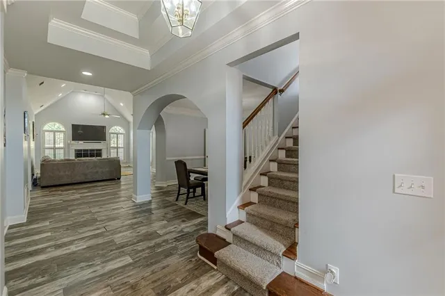 a spacious bedroom with a bed and a chandelier