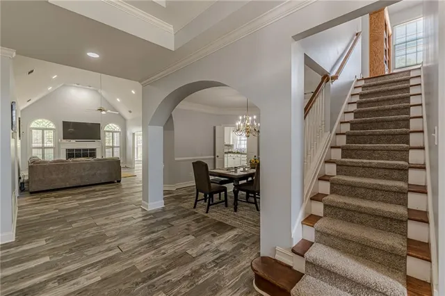 a spacious bedroom with a bed and a flat screen tv