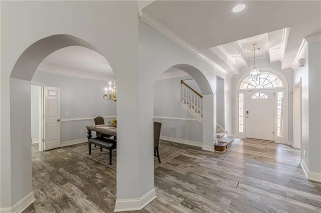 a spacious bedroom with a bed and a flat screen tv