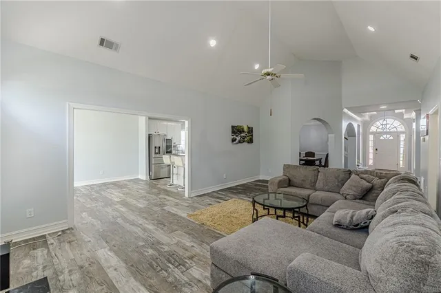 a view of a dining room with furniture a chandelier and wooden floor