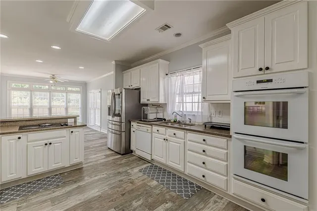 a view of a dining room with furniture and chandelier