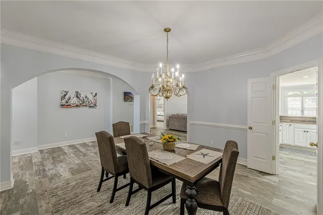 a view of a dining room with furniture and chandelier
