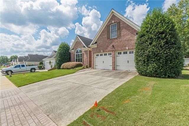 a front view of a house with a yard and garage