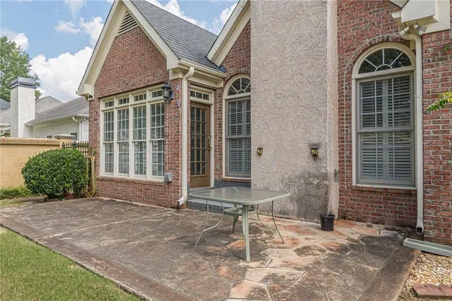 a view of a hallway with wooden floor and a living room