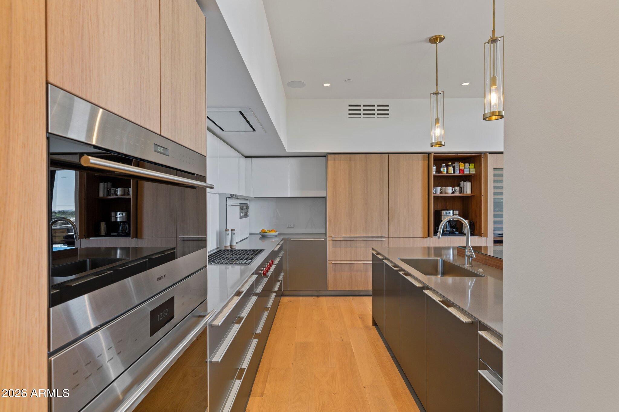 5000 North Camelback Ridge Drive, Unit 208 Scottsdale, AZ 85251 - Photo 15 of 53 a kitchen with stainless steel appliances kitchen island granite countertop a sink and cabinets