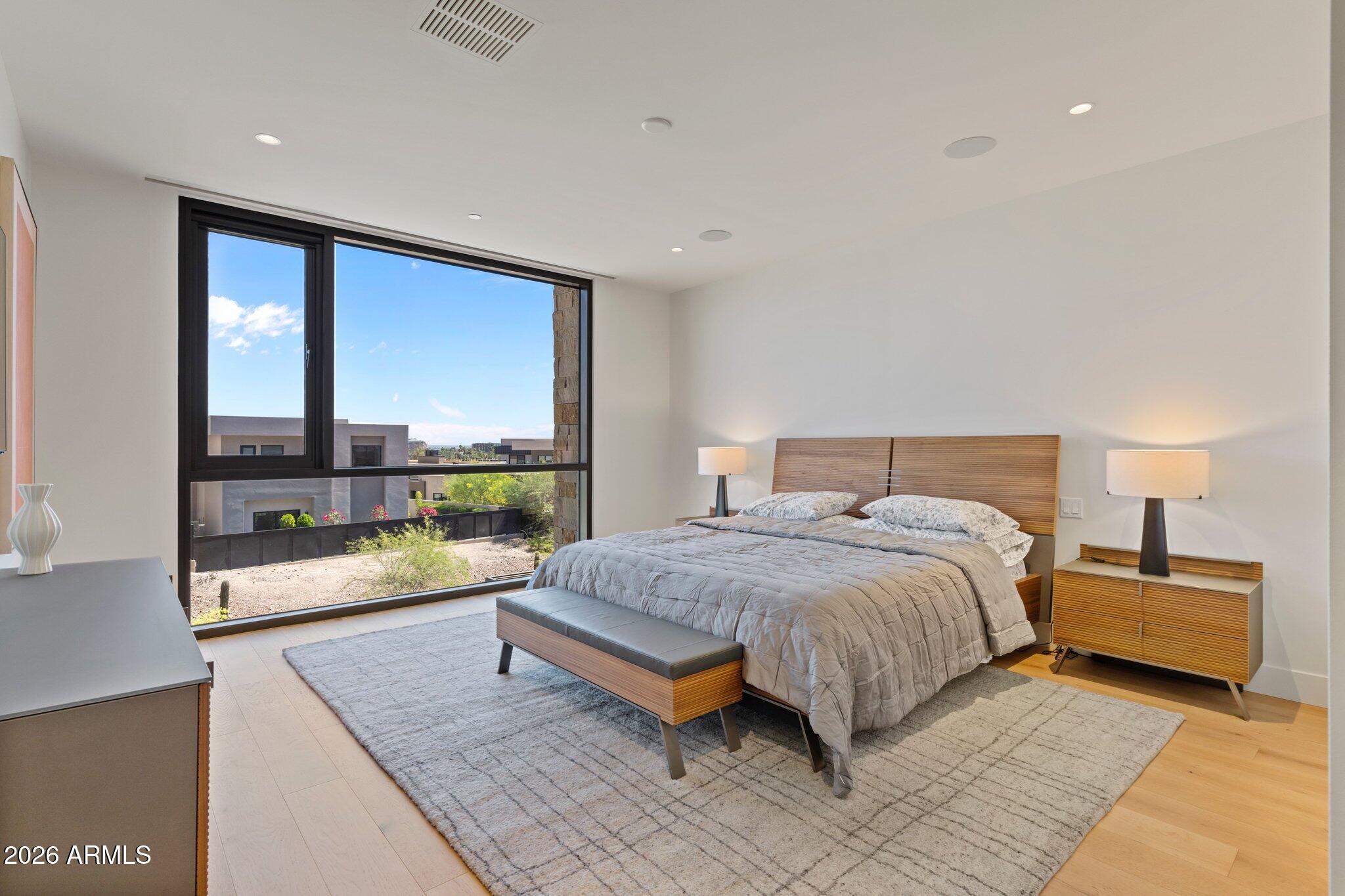 5000 North Camelback Ridge Drive, Unit 208 Scottsdale, AZ 85251 - Photo 24 of 53 a bedroom with a large bed and a large window