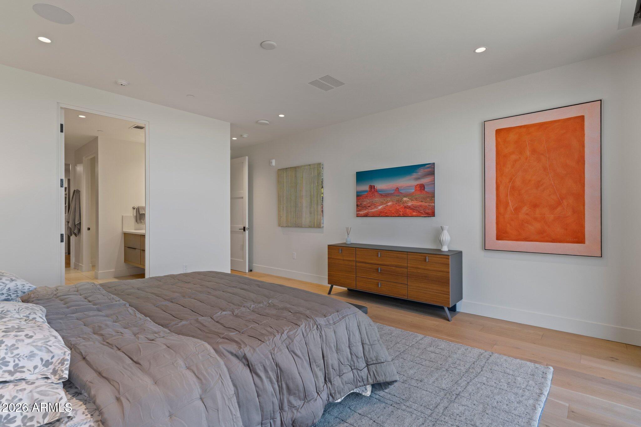 5000 North Camelback Ridge Drive, Unit 208 Scottsdale, AZ 85251 - Photo 25 of 53 a bedroom with a bed and a painting on the wall