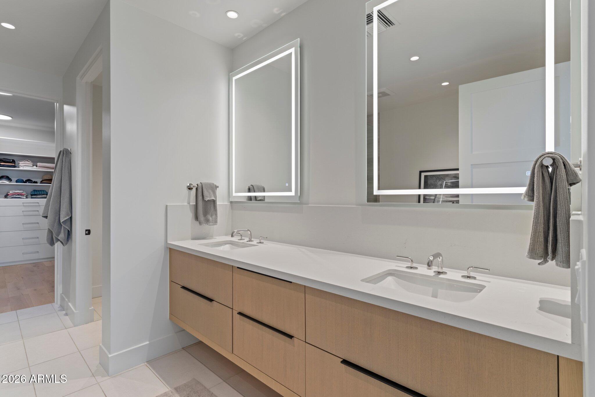 5000 North Camelback Ridge Drive, Unit 208 Scottsdale, AZ 85251 - Photo 26 of 53 a bathroom with a double vanity sink a mirror and shower