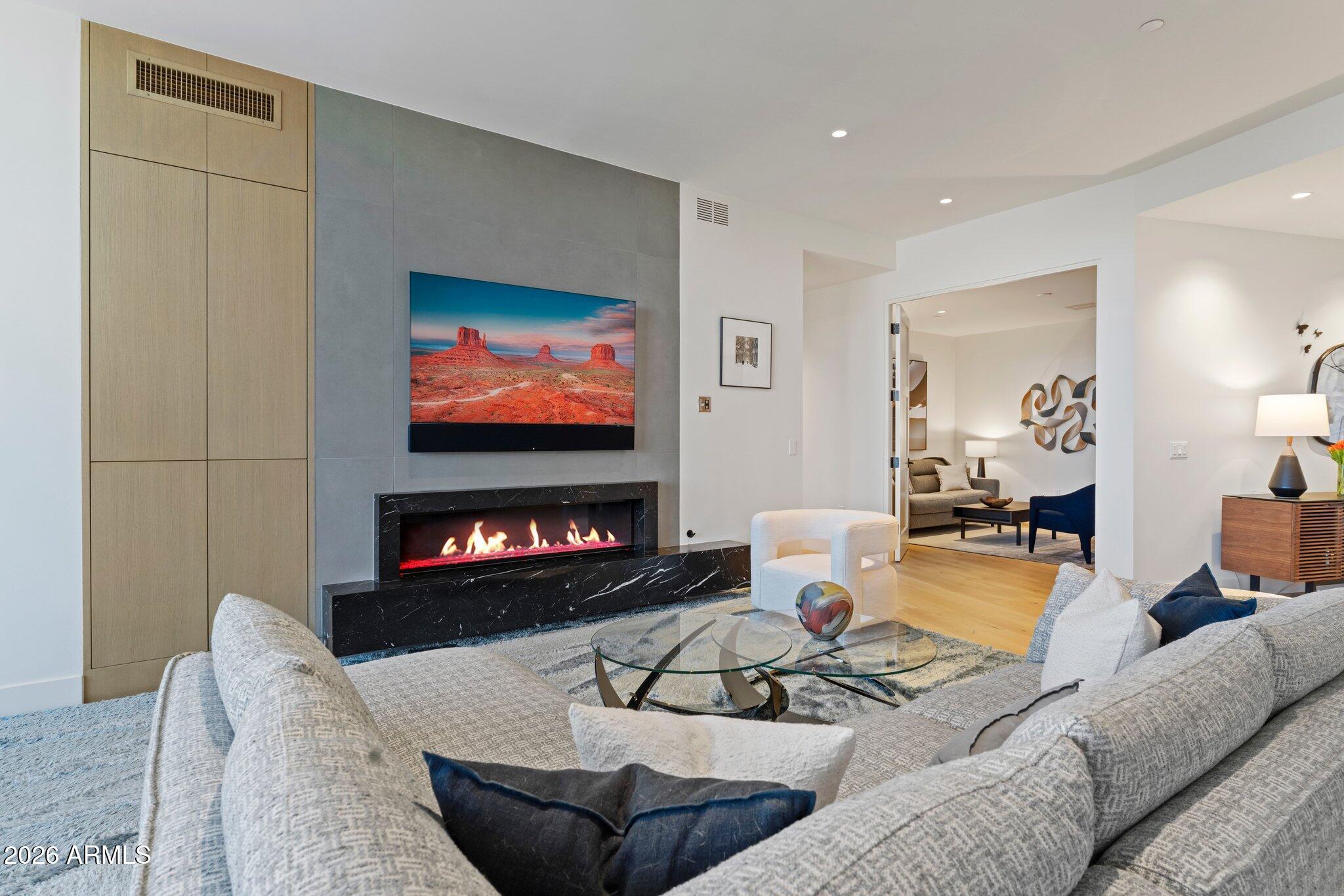 5000 North Camelback Ridge Drive, Unit 208 Scottsdale, AZ 85251 - Photo 2 of 53 a living room with furniture and a flat screen tv