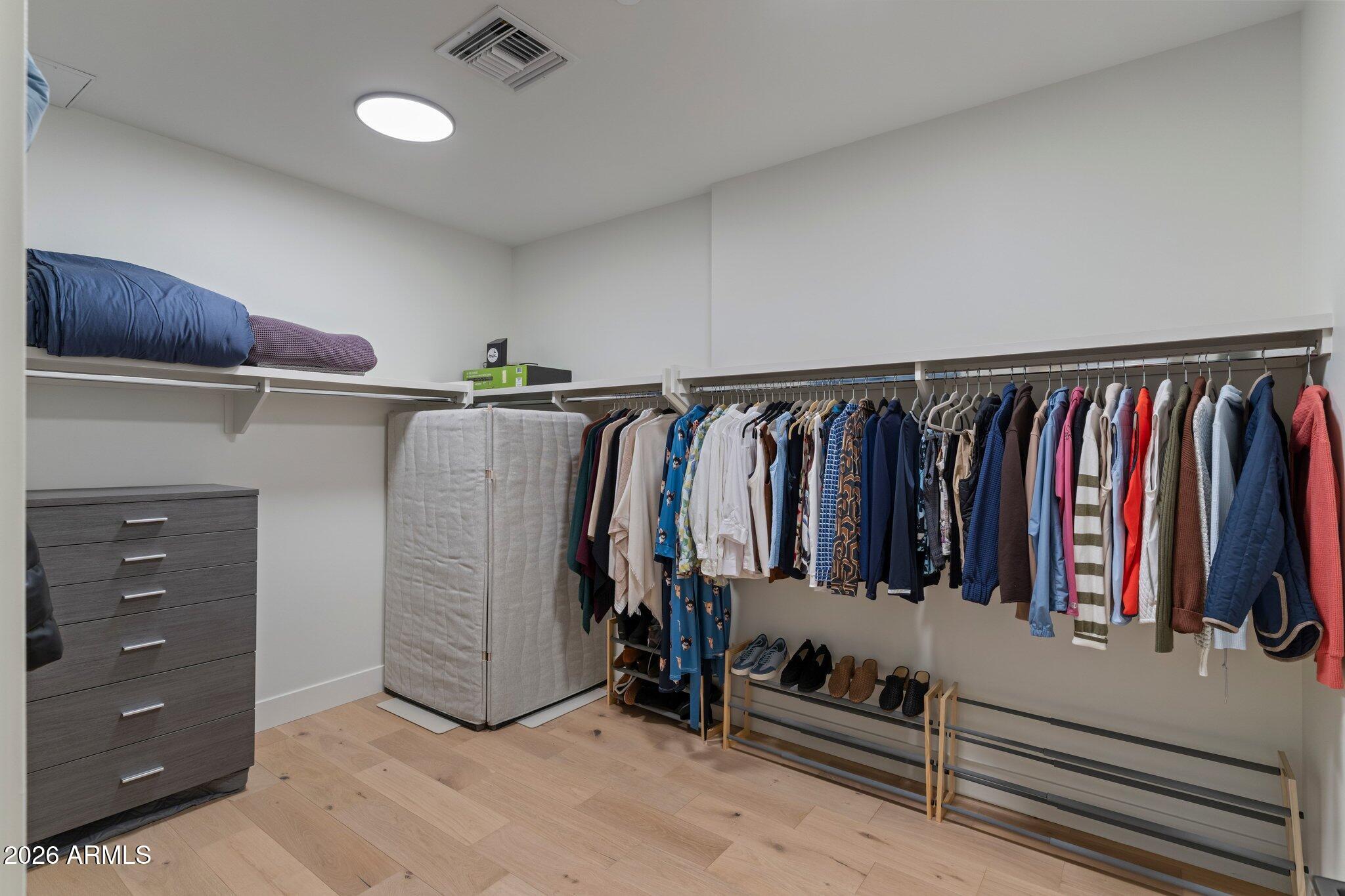 5000 North Camelback Ridge Drive, Unit 208 Scottsdale, AZ 85251 - Photo 35 of 53 a view of walk in closet with clothes and shoes