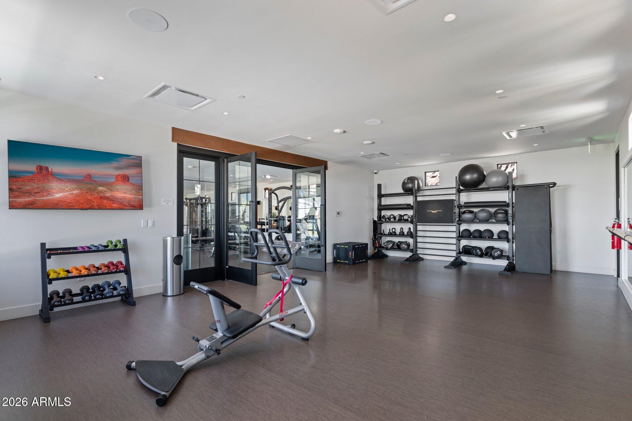 5000 North Camelback Ridge Drive, Unit 208 Scottsdale, AZ 85251 - Photo 40 of 53 a view of a room with gym equipment and a large window