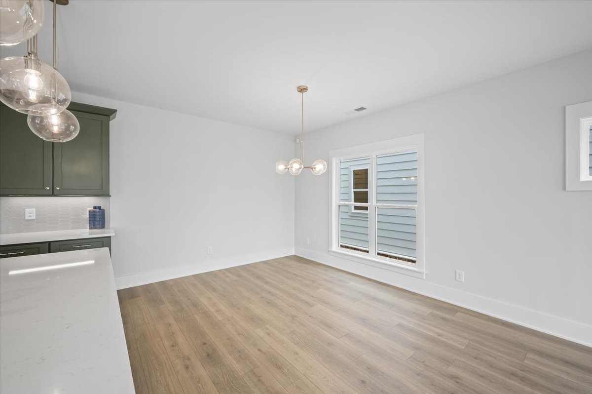 3045 B Hillside Road Nashville, TN 37207 - Photo 12 of 32 an empty room with wooden floor and windows