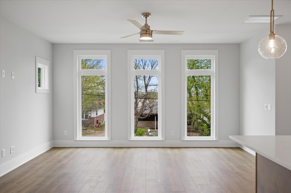 3045 B Hillside Road Nashville, TN 37207 - Photo 13 of 32 a view of an empty room with a window and wooden floor