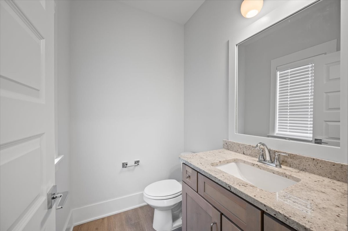 3045 B Hillside Road Nashville, TN 37207 - Photo 14 of 32 a bathroom with a granite countertop sink a toilet and a mirror