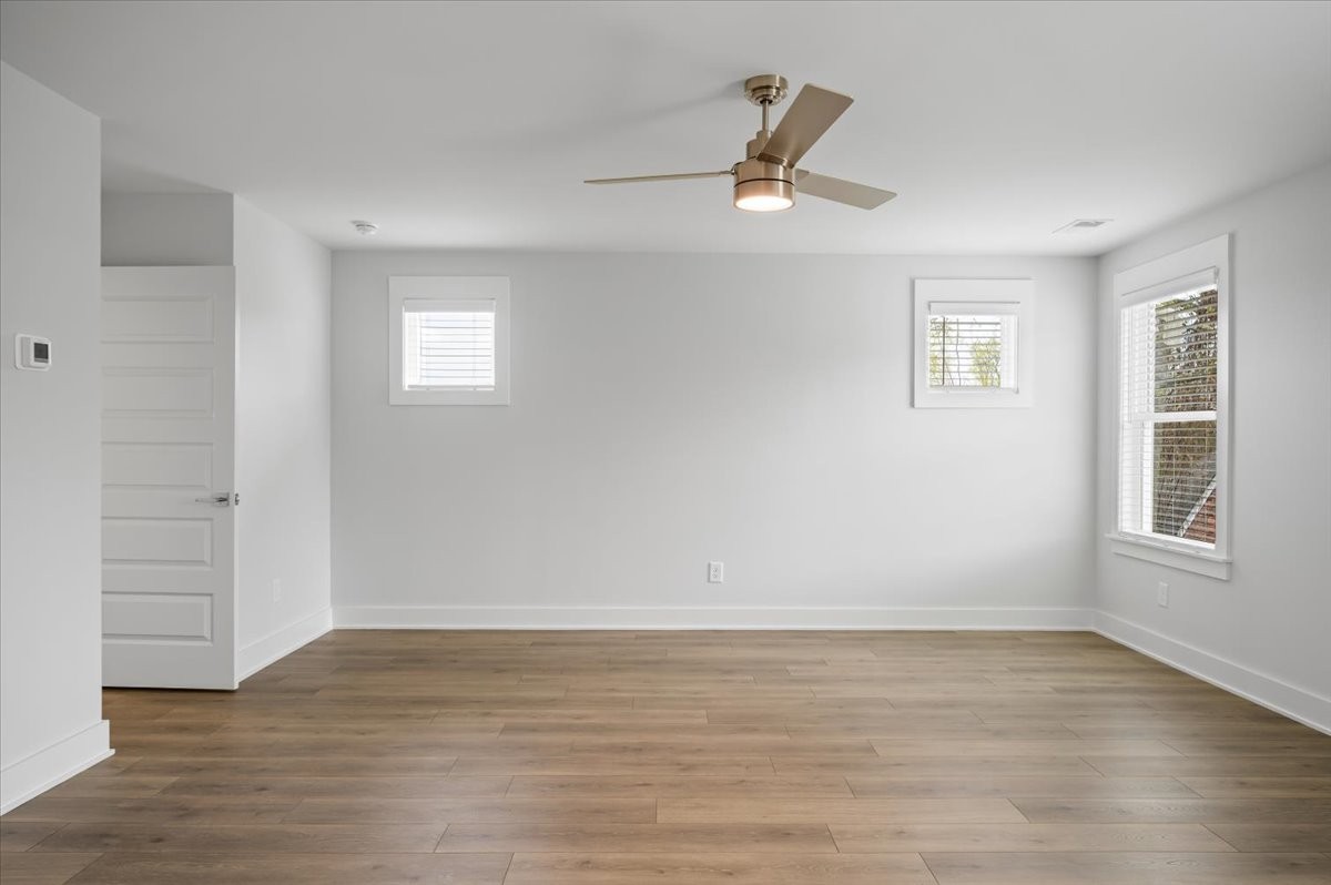 3045 B Hillside Road Nashville, TN 37207 - Photo 15 of 32 an empty room with wooden floor chandelier and windows