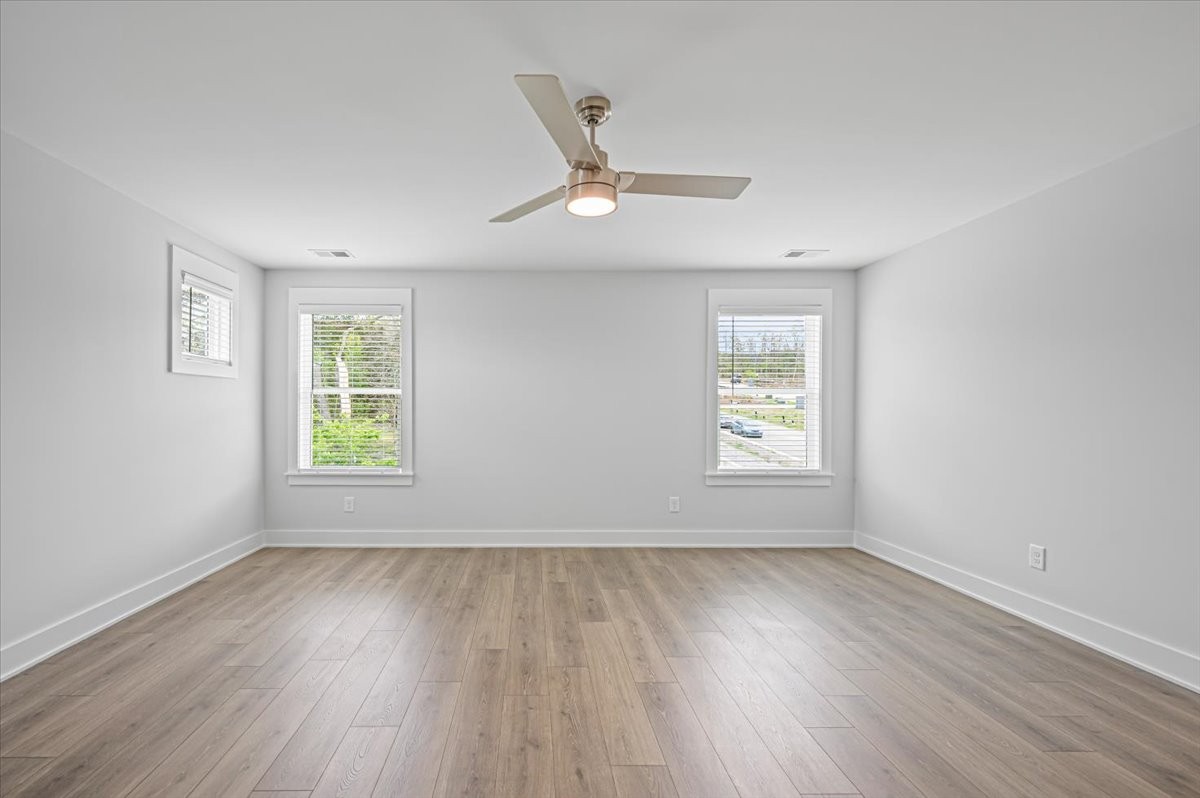 3045 B Hillside Road Nashville, TN 37207 - Photo 16 of 32 an empty room with wooden floor ceiling fan and windows